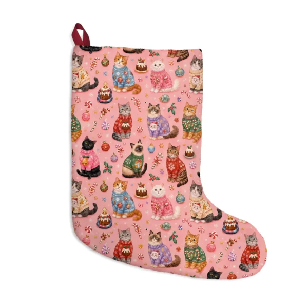 Coral pink stocking covered in cats wearing knitted Christmas sweaters, puddings and candy canes