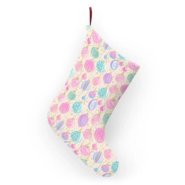 Back of the cream ornament stocking hanging from its ribbon loop, showing the same pastel print