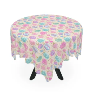 Round table under a cream tablecloth scattered with pink, mint and blue hanging baubles