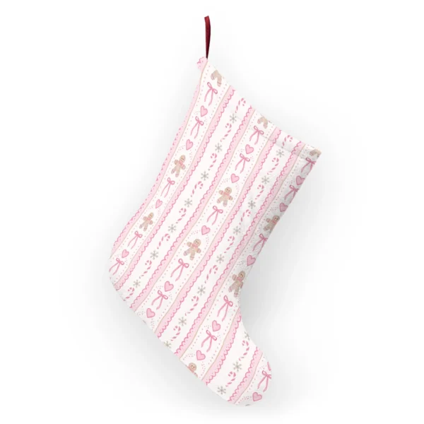 Back of the pink gingerbread stocking hanging from its ribbon loop with the striped print continuing