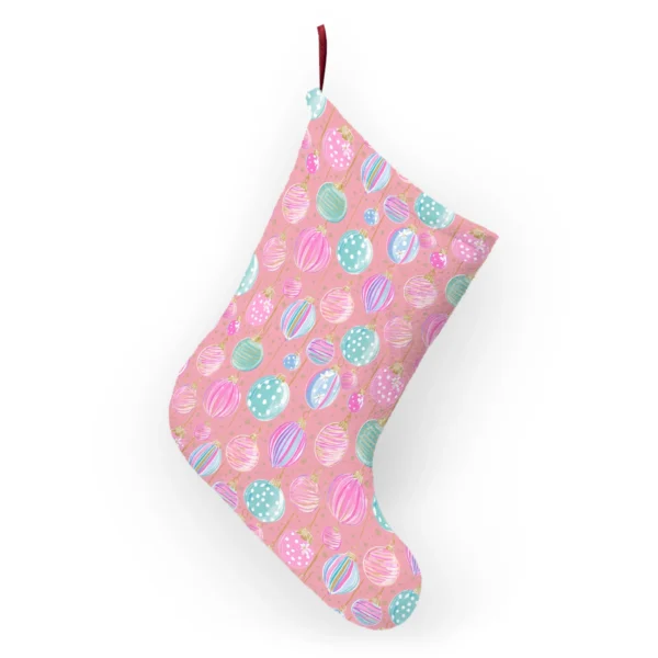 Back of the pink ornament stocking hanging from its ribbon loop, showing the pastel baubles