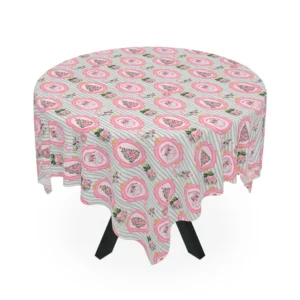 Round table draped in a sage-striped tablecloth with pink Santa portraits and floral Christmas trees