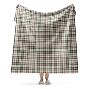 Person holding up a large cream plaid Christmas sherpa blanket with green bands and fine red lines