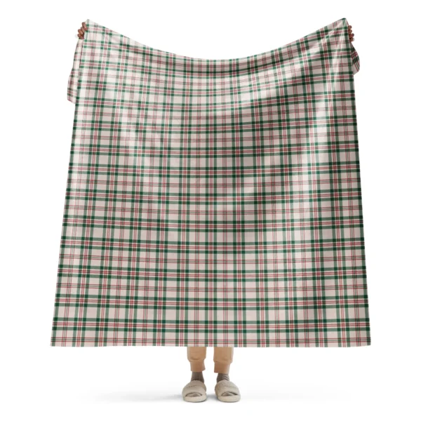 Person holding up a large cream plaid Christmas sherpa blanket with green bands and fine red lines