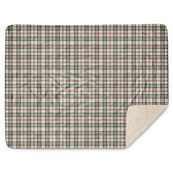 Plaid Christmas sherpa blanket laid flat with rounded corners, one corner folded over to show the sherpa