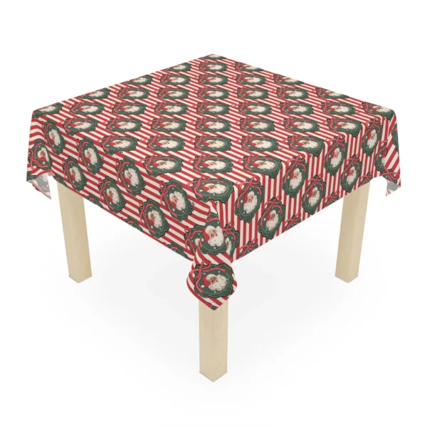 Small square table covered with a striped Christmas tablecloth printed with jolly Santa portraits