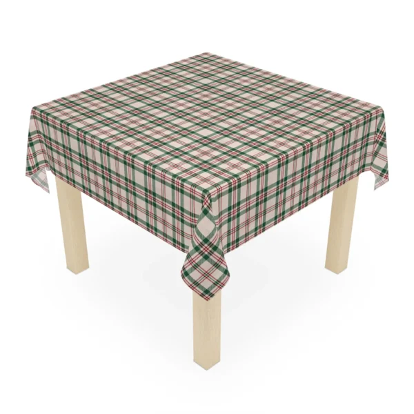 Square Christmas tablecloth in cream plaid laid over a small wooden table, one corner hanging at the front