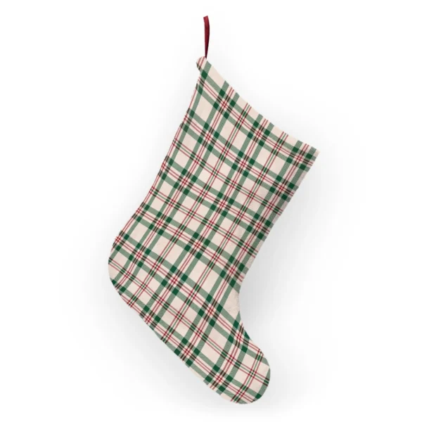 Green and red check Christmas stocking hanging from its ribbon loop, showing the plaid on the fleece