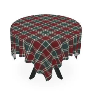 Round table covered with a burgundy and forest green tartan cloth crossed by thin cream lines