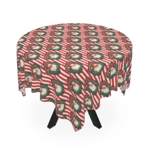 Round table under a red and cream striped tablecloth with vintage Santa faces in green frames with pink bows