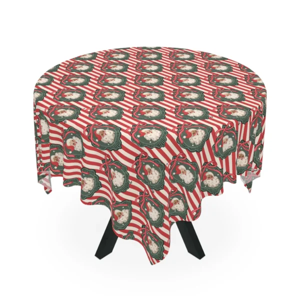 Round table under a red and cream striped tablecloth with vintage Santa faces in green frames with pink bows