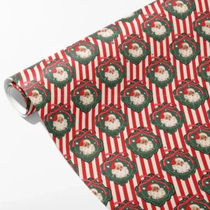 Roll of red and cream striped wrapping paper with vintage Santa faces in green scalloped frames, partly unrolled on white