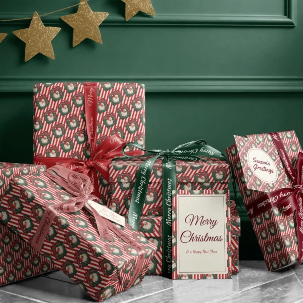 Stack of presents in vintage Santa red stripe paper with ribbons and a Merry Christmas card by a green wall