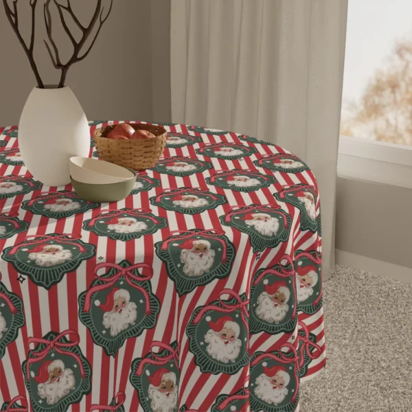 Detail of retro Santa medallions on candy-striped fabric next to a white vase and a basket of apples