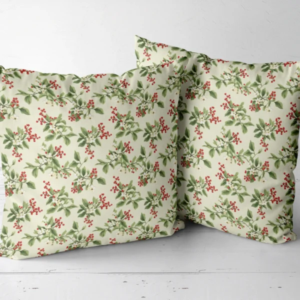 Two berry sprig throw pillows in cream, side by side