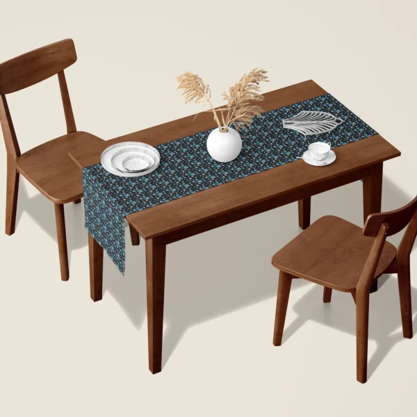 Blue snowflake Christmas table runner on a walnut dining table with two wooden chairs