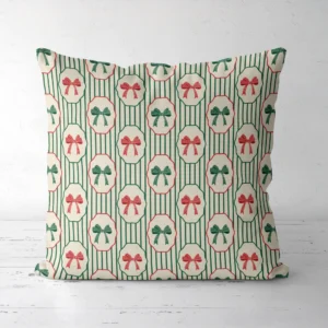 Bow medallion Christmas pillow facing forward, framed bows on green pinstripes
