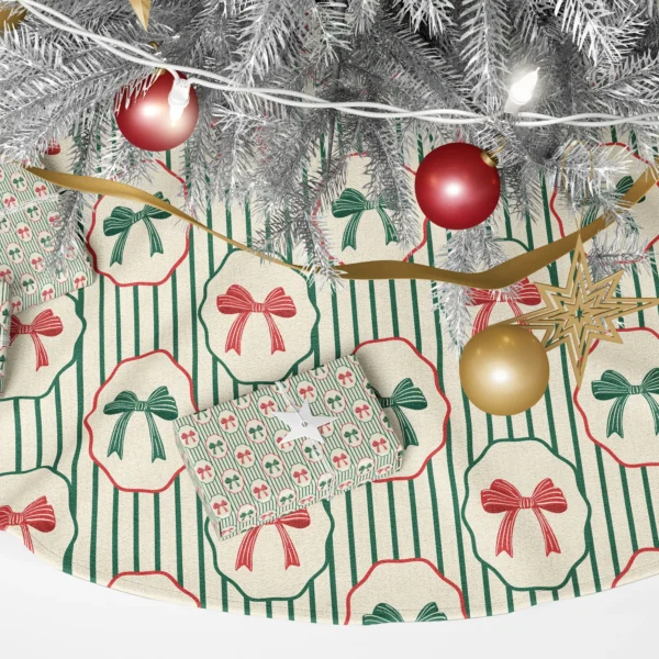 Close-up of a red bow and a green bow in scalloped cream frames over green pinstripes