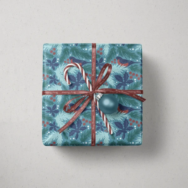 Top view of a gift in teal bullfinch paper with a ribbon, a candy cane and a bauble