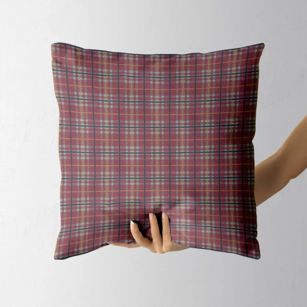 Hand holding the burgundy and sage country plaid pillow
