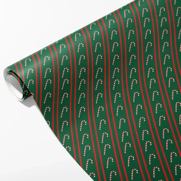Roll of green wrapping paper with thin red pinstripes and columns of small upright candy canes, partly unrolled on white