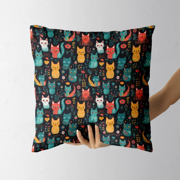 Hand holding a throw pillow with a folk-style cats on black print