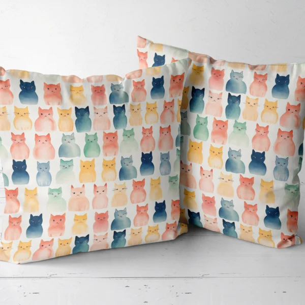 Two throw pillows with a watercolor cats on cream print side by side