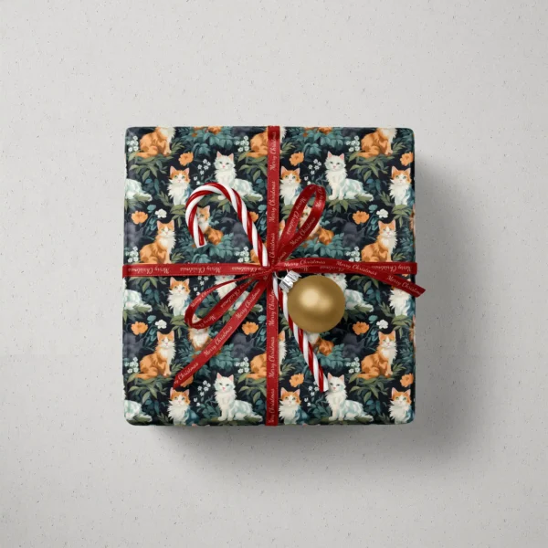 Top view of a gift in forest green cat paper with a red ribbon, a candy cane and a gold bauble