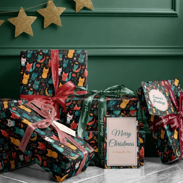 Stack of presents in black folk cat paper with ribbons and a Merry Christmas card by a dark green wall