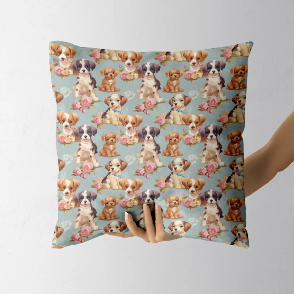 Hand holding a throw pillow with a puppies and pink roses on dusty blue print