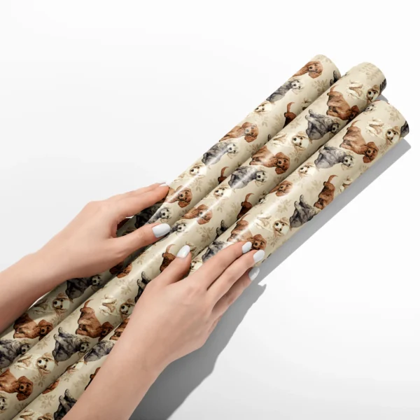 Hands smoothing three rolls of beige puppy wrapping paper on a white table