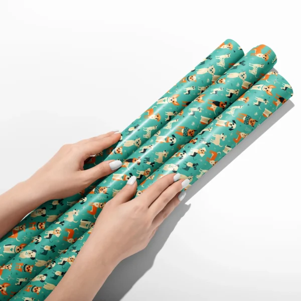 Hands smoothing three rolls of aqua retro dog wrapping paper on a white table