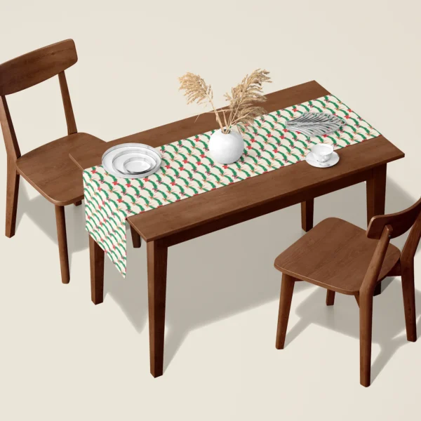 Pine garland and red bow Christmas table runner on a walnut dining table with two wooden chairs