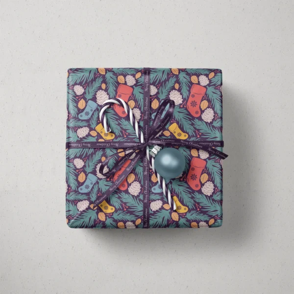 Top view of a gift in plum stocking paper with a ribbon, a candy cane and a bauble