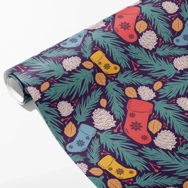 Roll of plum wrapping paper with red, blue and yellow stockings, teal pine and cream pine cones, partly unrolled on white