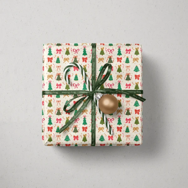 Top view of a gift in Christmas tree and bow paper with a ribbon, candy canes and a bauble