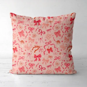 Coquette bow Christmas pillow facing forward on a white floor