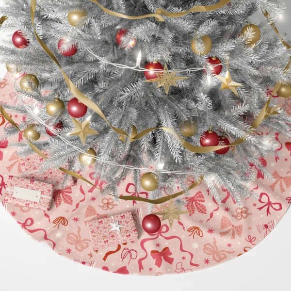 Pink coquette bow tree skirt under a lit Christmas tree with presents
