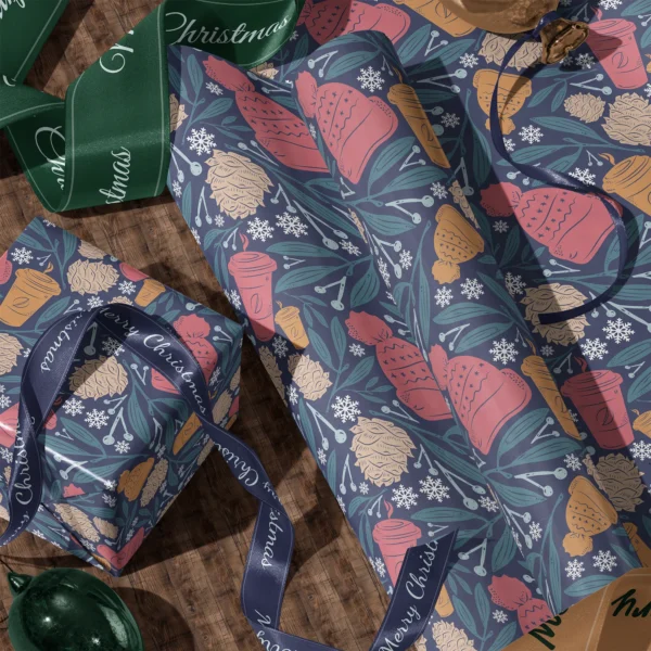 A sheet of navy cozy winter gift wrap and a wrapped box with satin ribbons on a wooden floor