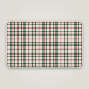 Cream plaid Christmas bath mat with a white bound edge, seen from above