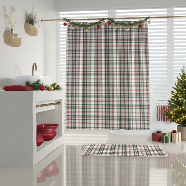 Cream plaid shower curtain in a white bathroom with red towels on a shelf and a decorated tree