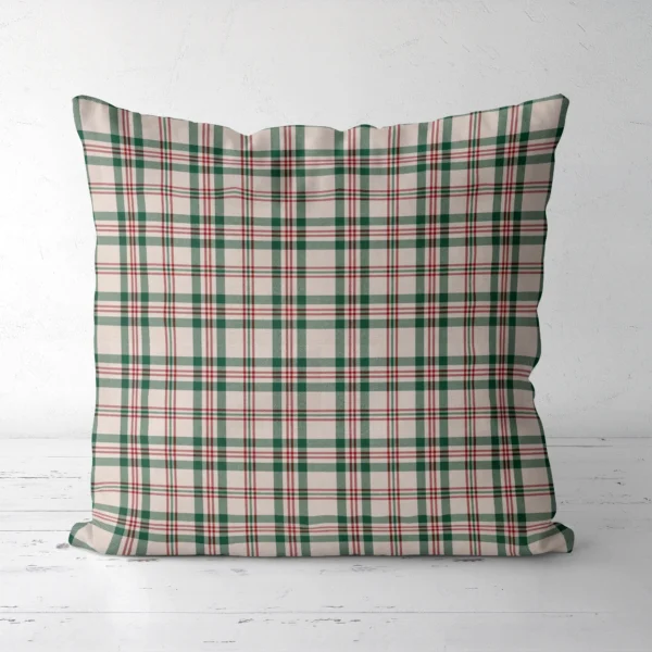Cream plaid Christmas pillow, front view, standing on a white floor