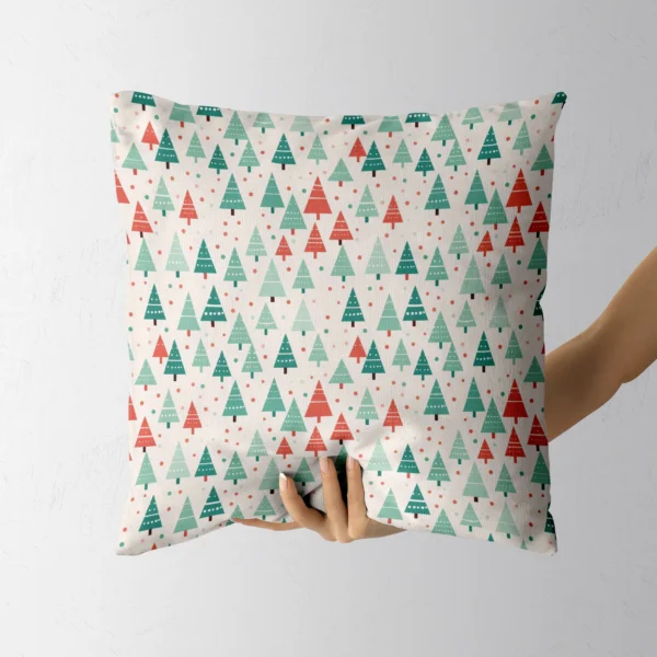 Someone holding the dotted tree Christmas pillow in one hand