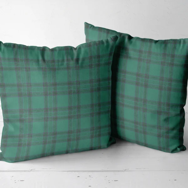 Two emerald green tartan throw pillows side by side