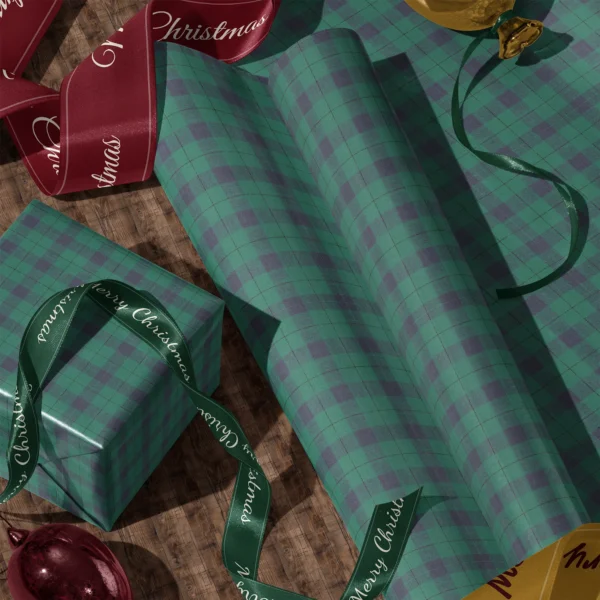 Rolls of emerald and navy check gift wrap and a wrapped box with satin ribbons on a wooden floor