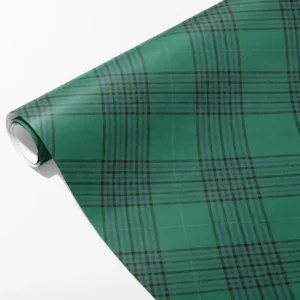 Roll of emerald windowpane plaid wrapping paper with wide green panes and slim plum and brown lines, partly unrolled
