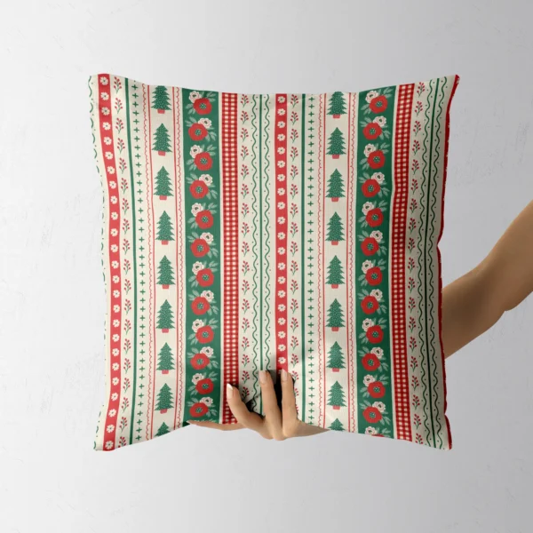 Hand holding the folk border throw pillow with trees and blooms