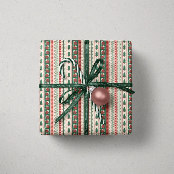 Top view of a gift in folk border paper with a ribbon, candy canes and a bauble