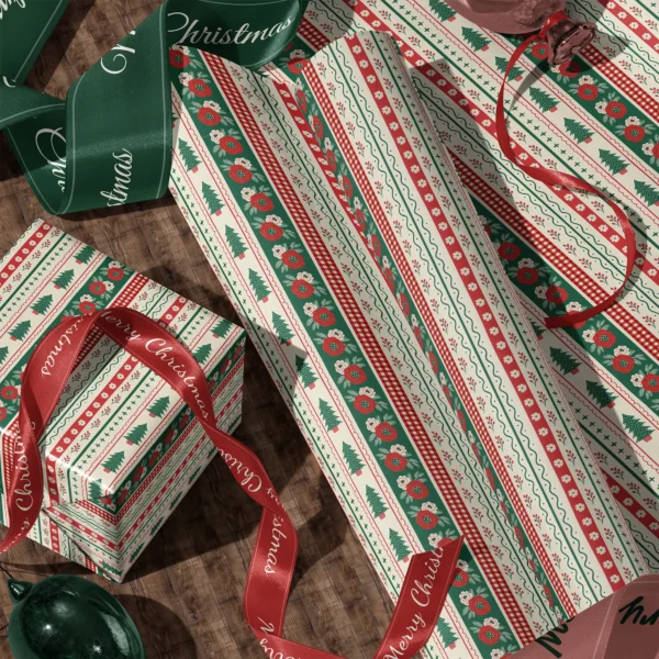 Rolls of folk border gift wrap and a wrapped box with satin ribbons on a wooden floor