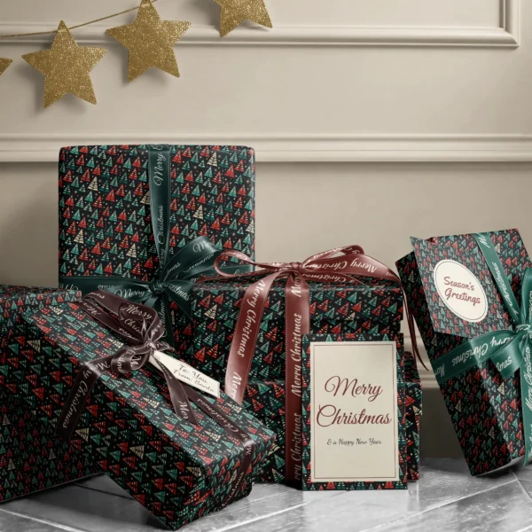 Stack of presents in black folk tree paper with ribbons and a Merry Christmas card by a beige wall